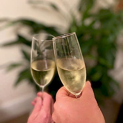 champagne glasses against a cardamom plant